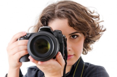 A woman takes a picture with her camera.