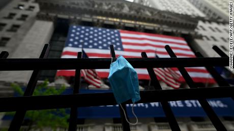 A face mask is seen in front of the New York Stock Exchange (NYSE) on May 26, 2020 at Wall Street in New York City. - Global stock markets climbed Monday, buoyed by the prospect of further easing of coronavirus lockdowns despite sharp increases in case rates in some countries such as Brazil. Over the weekend, US President Donald Trump imposed travel limits on Brazil, now the second worst affected country after the United States, reminding markets that while the coronavirus outlook is better, the crisis is far from over. (Photo by Johannes EISELE / AFP) (Photo by JOHANNES EISELE/AFP via Getty Images)